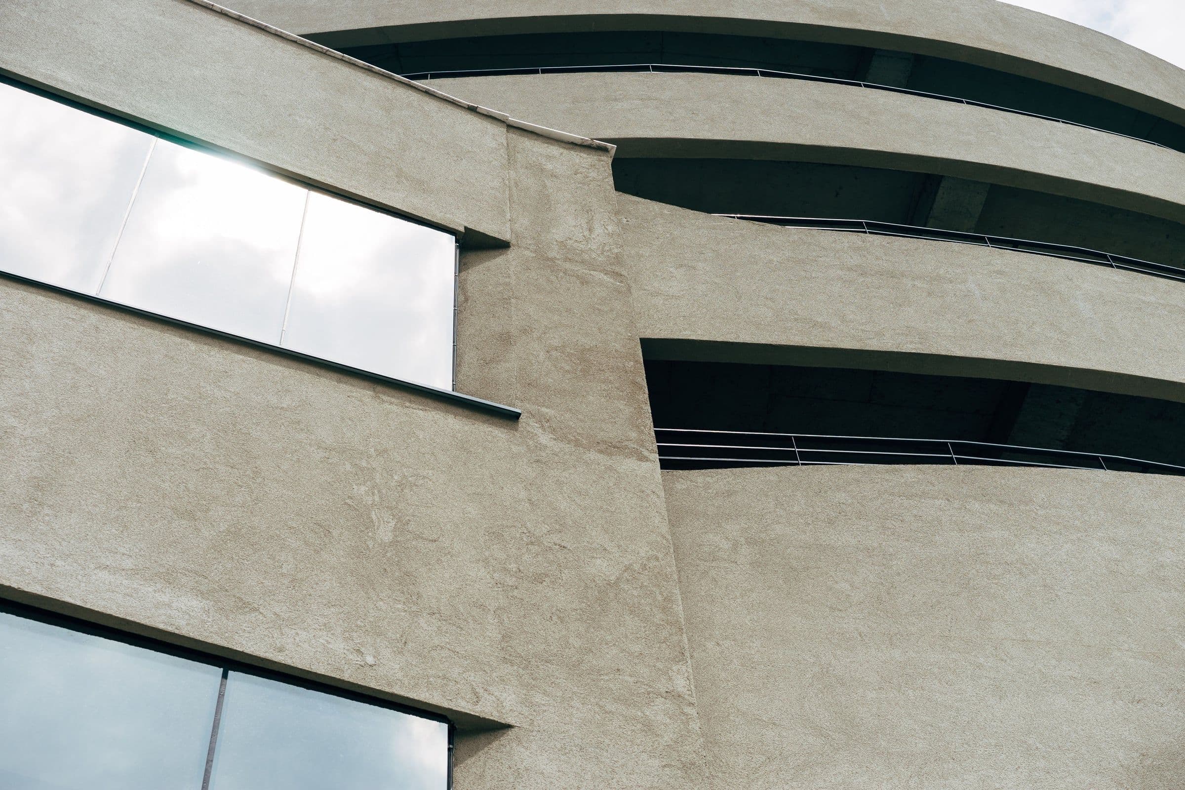 Curved concrete balcony returning around the upper gallery