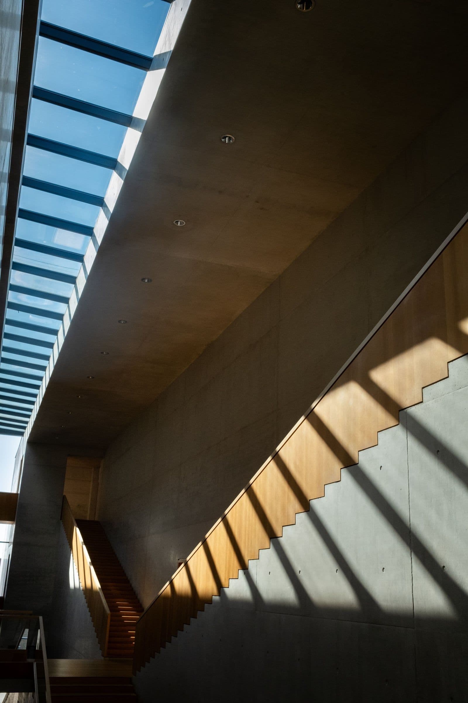 Concrete stairwell at the studio's own workshop, skylight above